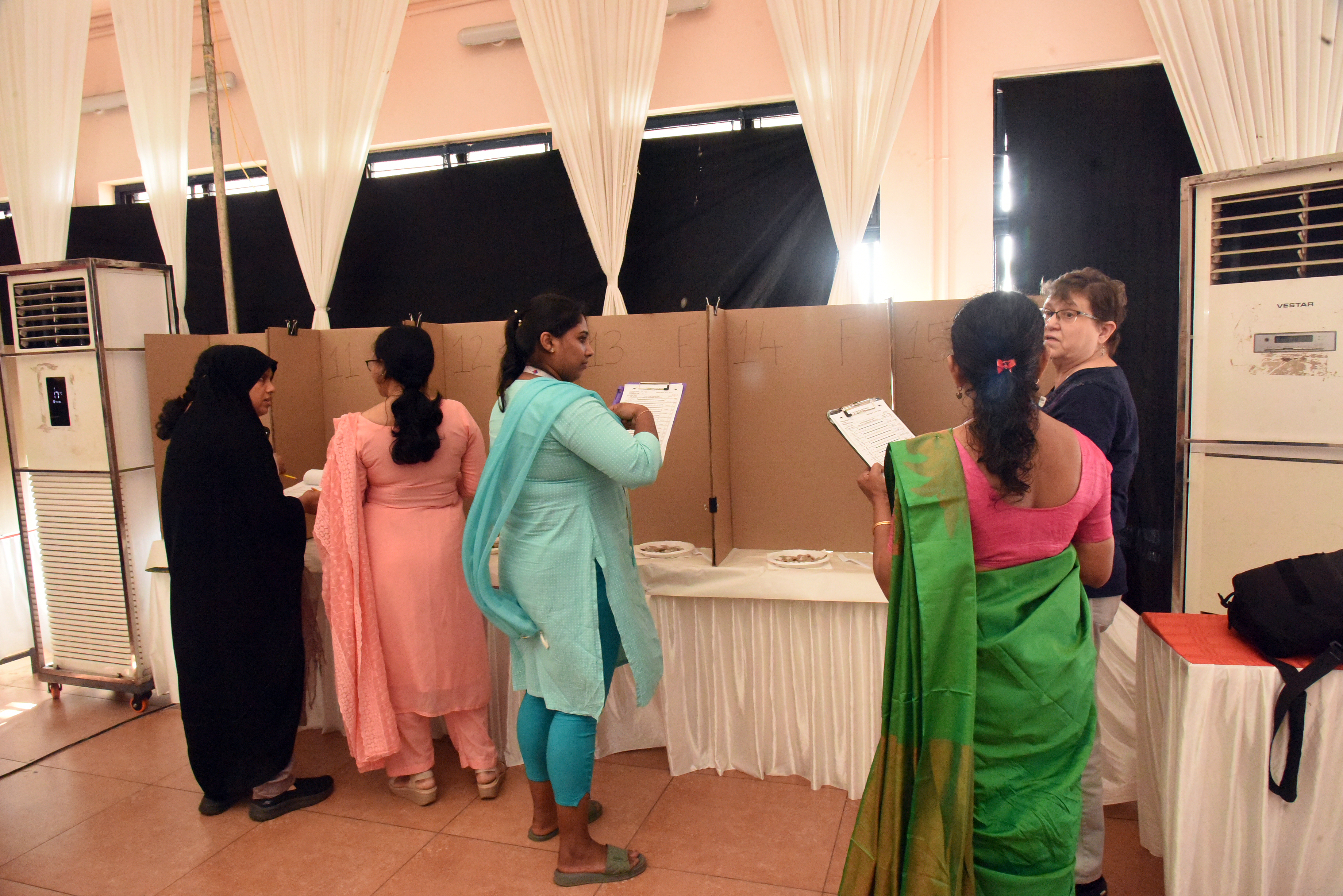 Indian women participating in the trainings record observations on the shrimp.